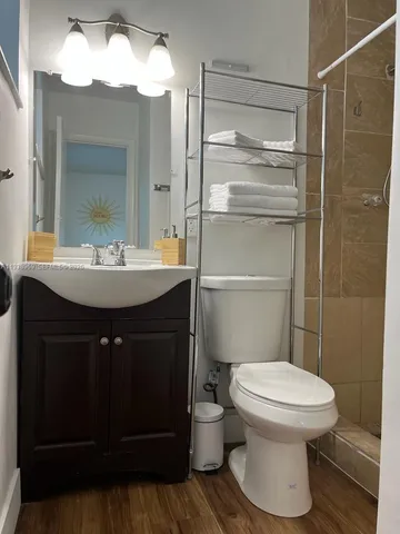 a bathroom with a sink toilet and shower