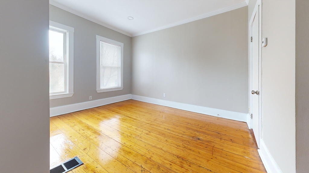 46-48 Fuller Street, Unit 48 1 Boston, MA 02124 - Photo 5 of 8 a view of empty room with window and wooden floor