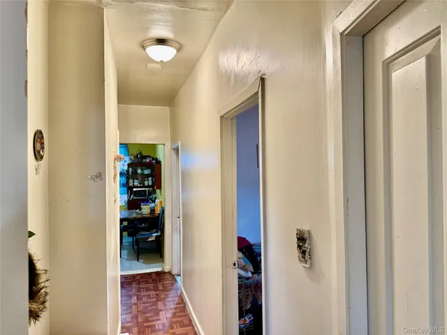 a view of a hallway with closet and mirrors