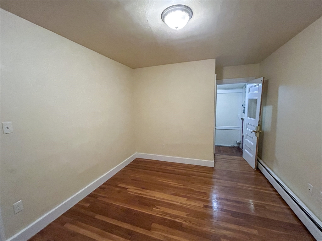 1911 River Street, Unit 2 Boston, MA 02136 - Photo 6 of 16 a view of an empty room with wooden floor