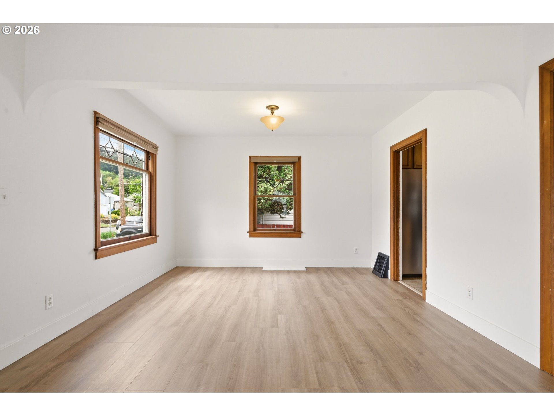 1804 Division Street Camas, WA 98607 - Photo 9 of 43 a view of an empty room with window and wooden floor