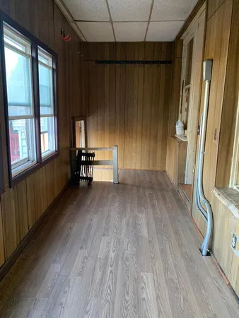 a view of a kitchen with fridge and wooden floor