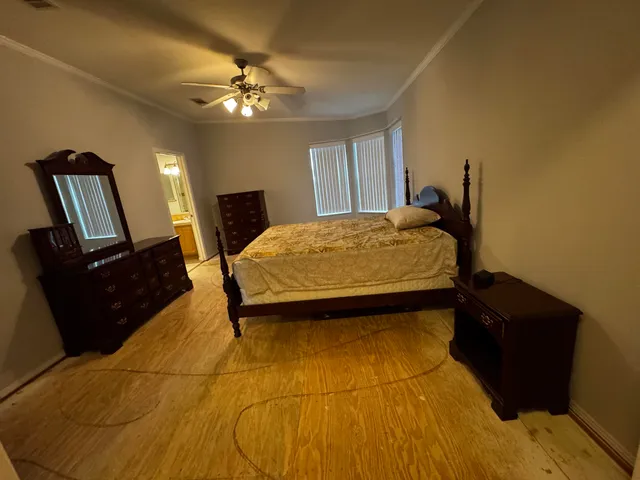 a bedroom with a bed and mirror