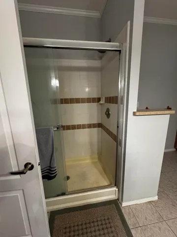 a bathroom with a glass shower door