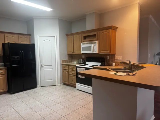 a kitchen with stainless steel appliances a sink stove and refrigerator