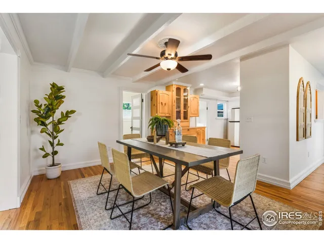 a view of a dining room with furniture and a potted plant