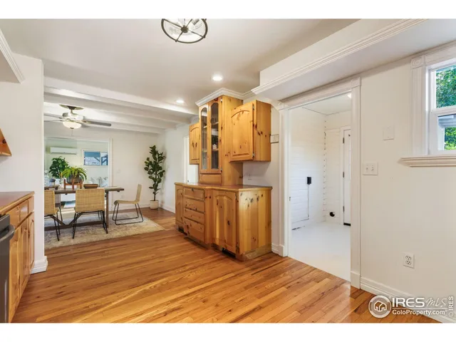 a view of a livingroom with furniture a chandelier and wooden floor
