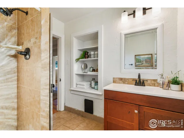 a bathroom with a sink vanity and a mirror