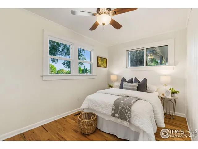 a bedroom with a bed and a painting on the wall