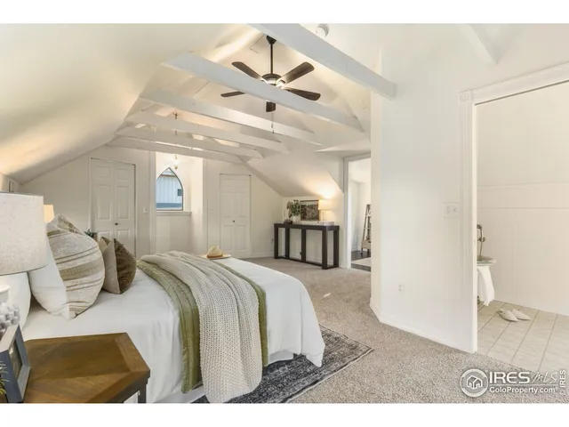 a bedroom with a bed and a mirror