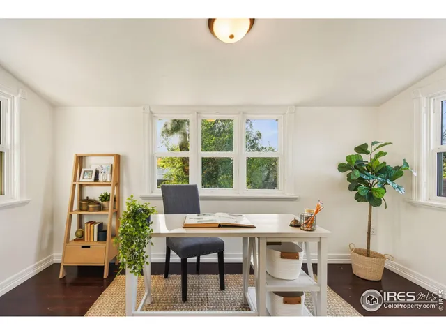 a workspace with furniture and a potted plant