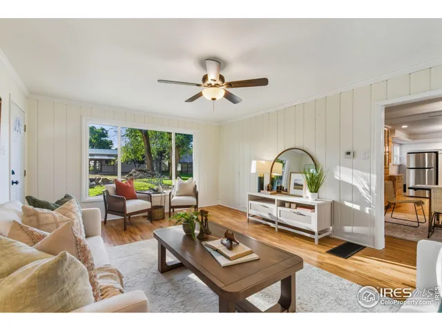 a living room with furniture a rug and a window