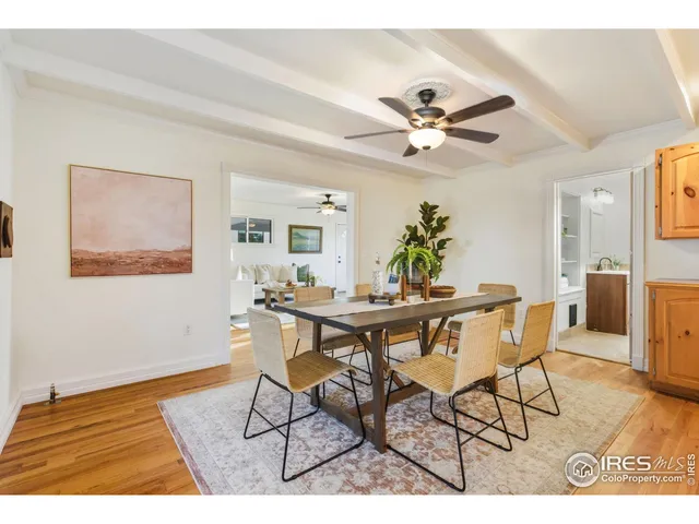 a view of a dining room with furniture and a chandelier fan