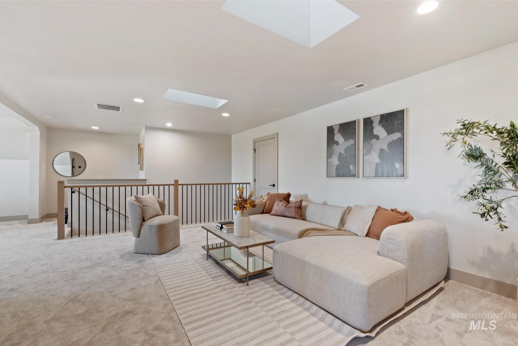 8530 West Graye Street, Unit SHASTA Meridian, ID 83646 - Photo 27 of 28 Living room featuring a skylight, recessed lighting, and light carpet