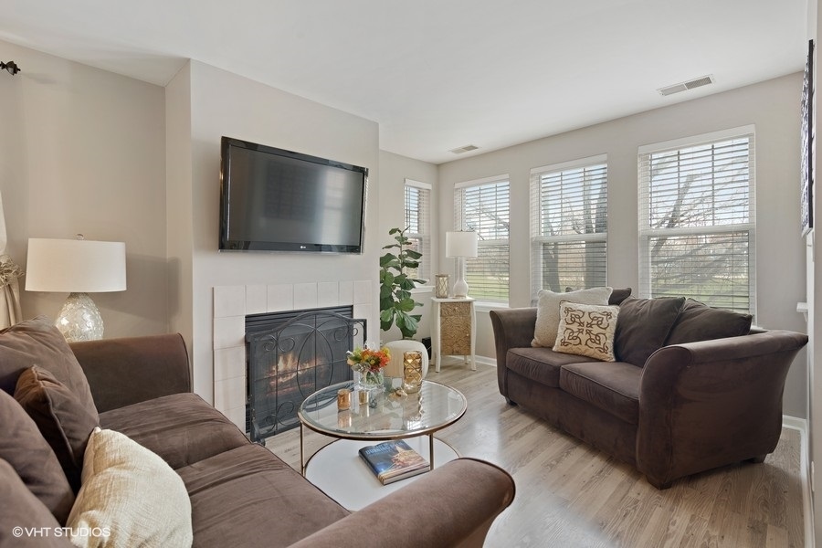 649 West Division Street, Unit B Chicago, IL 60610 - Photo 2 of 15 a living room with furniture a fireplace and a flat screen tv