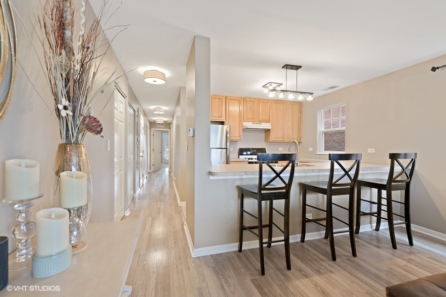 649 West Division Street, Unit B Chicago, IL 60610 - Photo 5 of 15 a view of a dining room with furniture and wooden floor