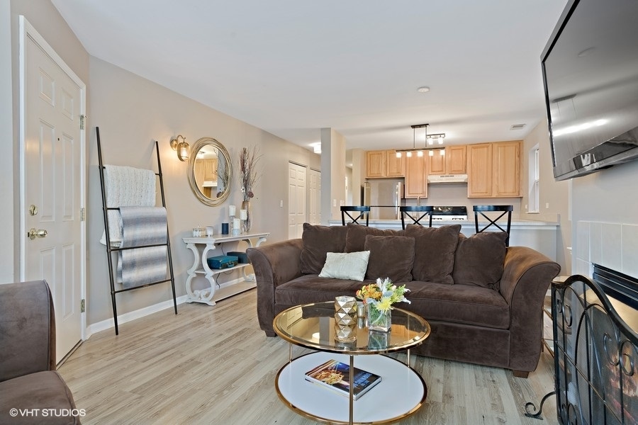 649 West Division Street, Unit B Chicago, IL 60610 - Photo 7 of 15 a living room with furniture kitchen view and a wooden floor