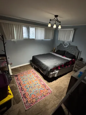 a bed sitting in a room next to a window