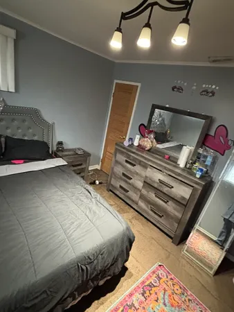 a bedroom with bed and window