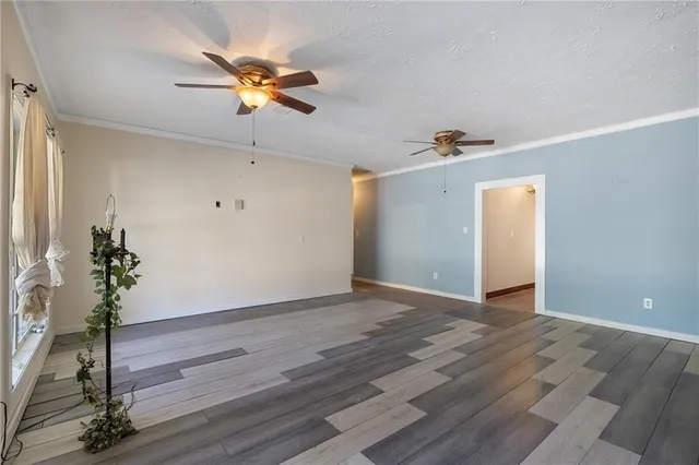 a view of an empty room and wooden floor