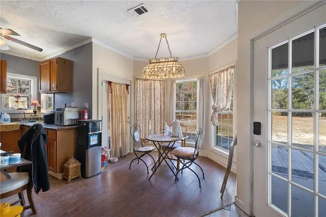 a dining room with furniture window and outside view
