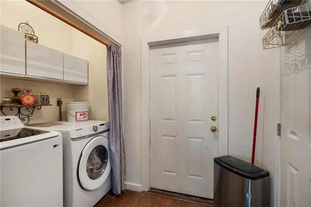 a view of a storage and utility room with dryer and washer