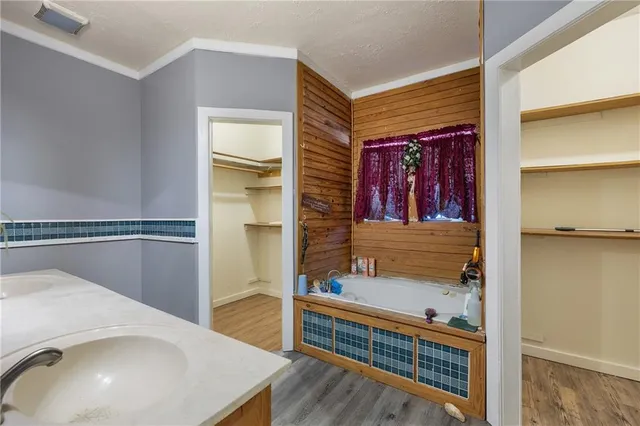 a view of a hallway with entryway and wooden floor