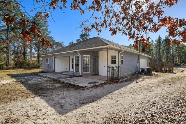 a view of a yard with a house and a tree