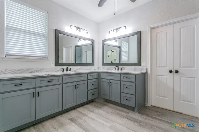 a spacious bathroom with double vanity sink and a mirror