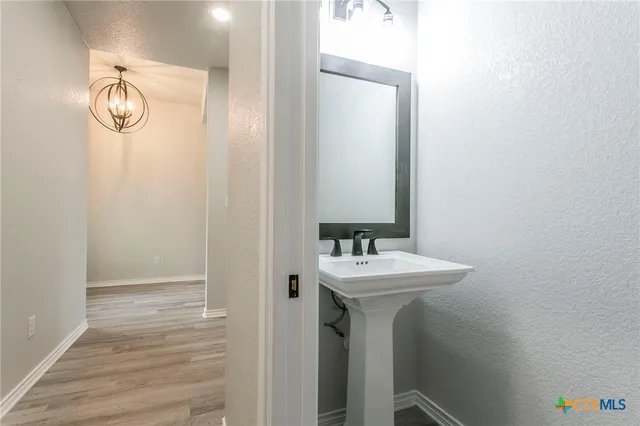 a bathroom with a sink a mirror and shower view