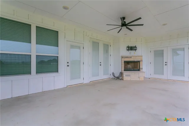 an empty room with fireplace and a window
