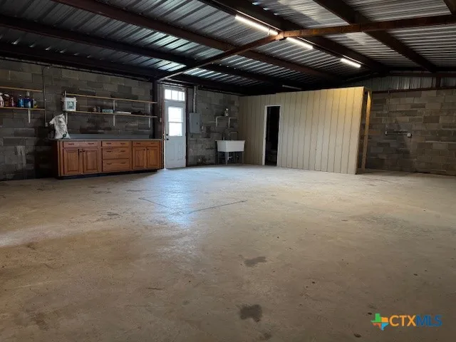 an empty room with furniture and a ceiling fan