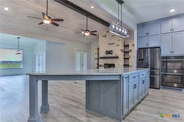 a kitchen with refrigerator cabinets and wooden floor