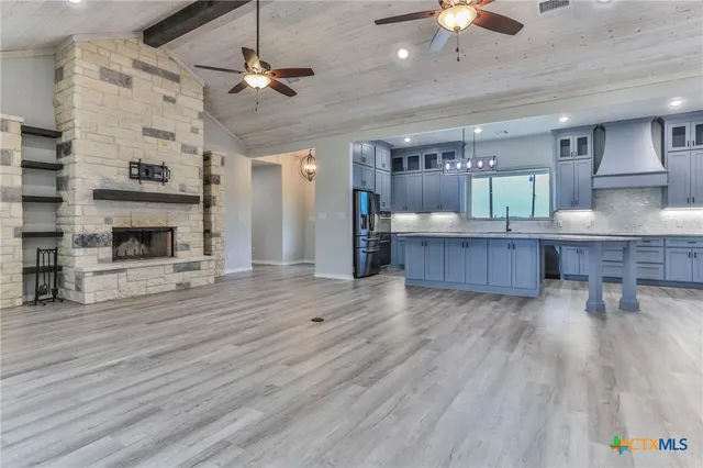 a view of kitchen and livingroom with furniture wooden floor