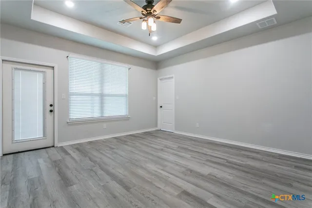 wooden floor in an empty room with a window