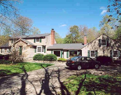 184 Godfrey Road East Weston, CT 06883 - Photo 1 of 1 a front view of a house with a yard and outdoor seating