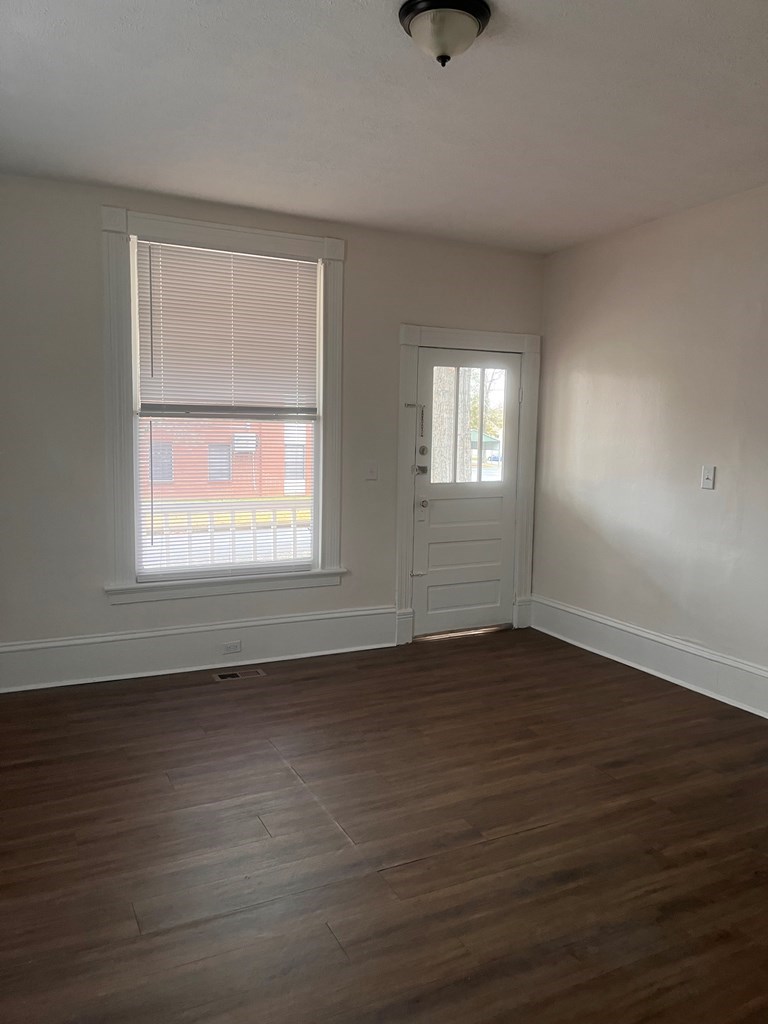 1348 Rhodes Street Columbus, GA 31901 - Photo 3 of 11 an empty room with wooden floor and windows