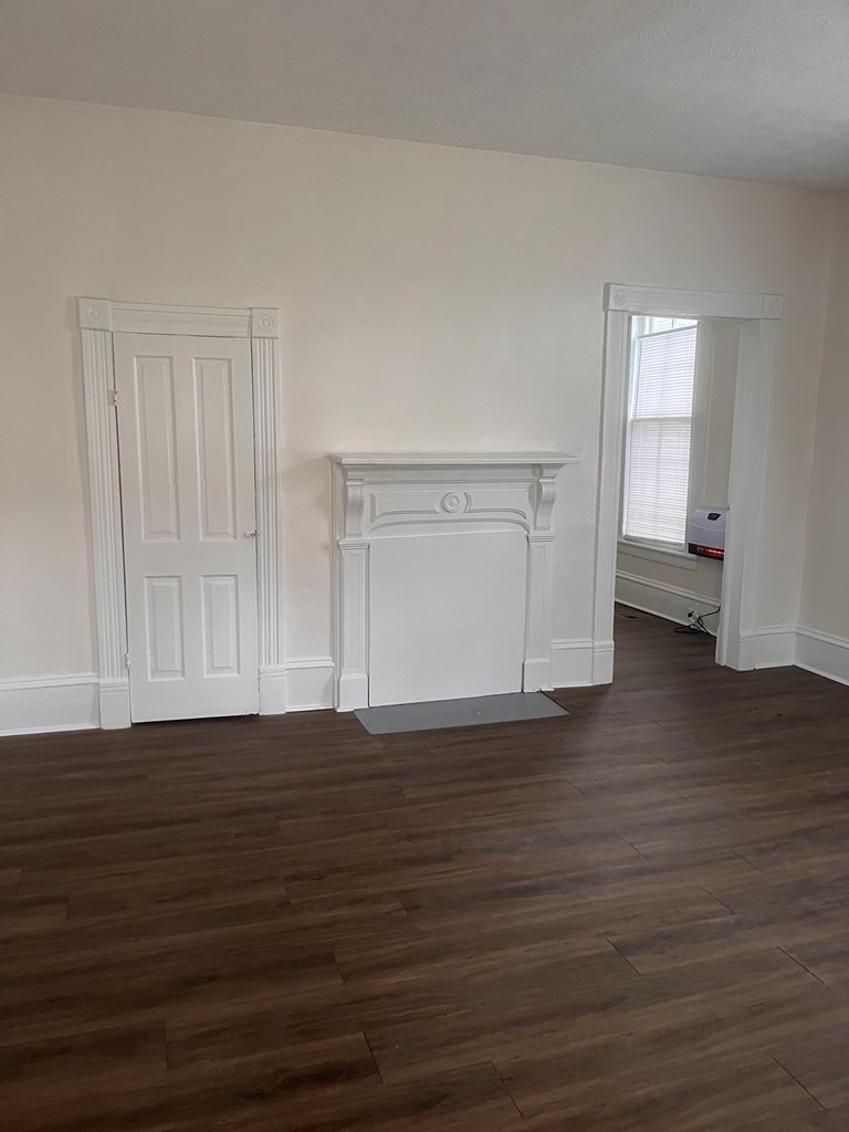 1348 Rhodes Street Columbus, GA 31901 - Photo 4 of 11 a view of an empty room with wooden floor and cabinet