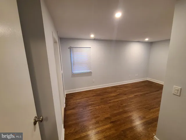 a view of hallway with wooden floor