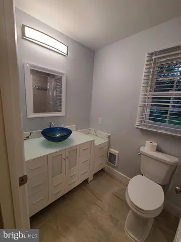 a bathroom with a toilet and a bathtub