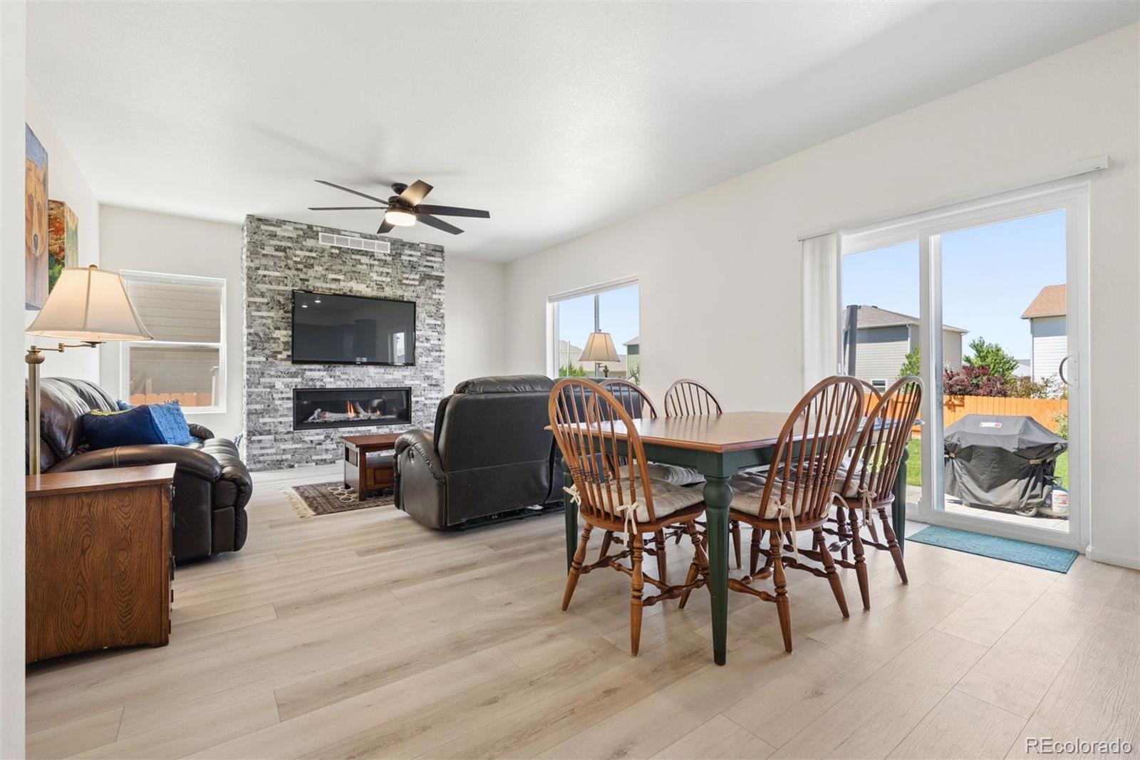 7307 Animas Avenue Frederick, CO 80530 - Photo 15 of 49 a view of a dining room with furniture window and wooden floor