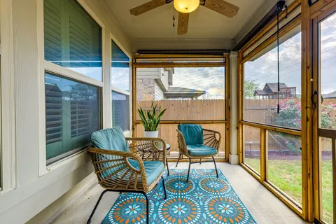 a living room with furniture and a floor to ceiling window