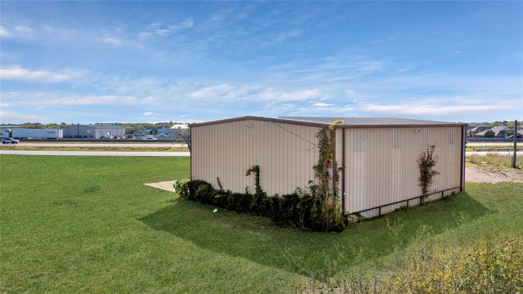 6000 Interstate 30 Fate, TX 75087 - Photo 12 of 18 a view of a backyard with grass and a tub