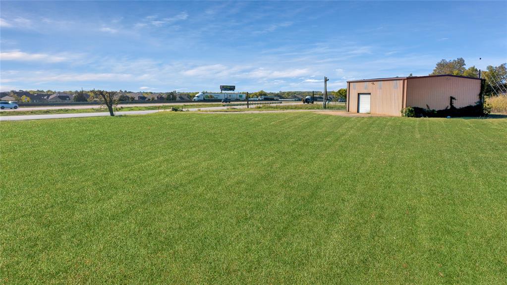 6000 Interstate 30 Fate, TX 75087 - Photo 10 of 18 a view of a house with a big yard and a large tree