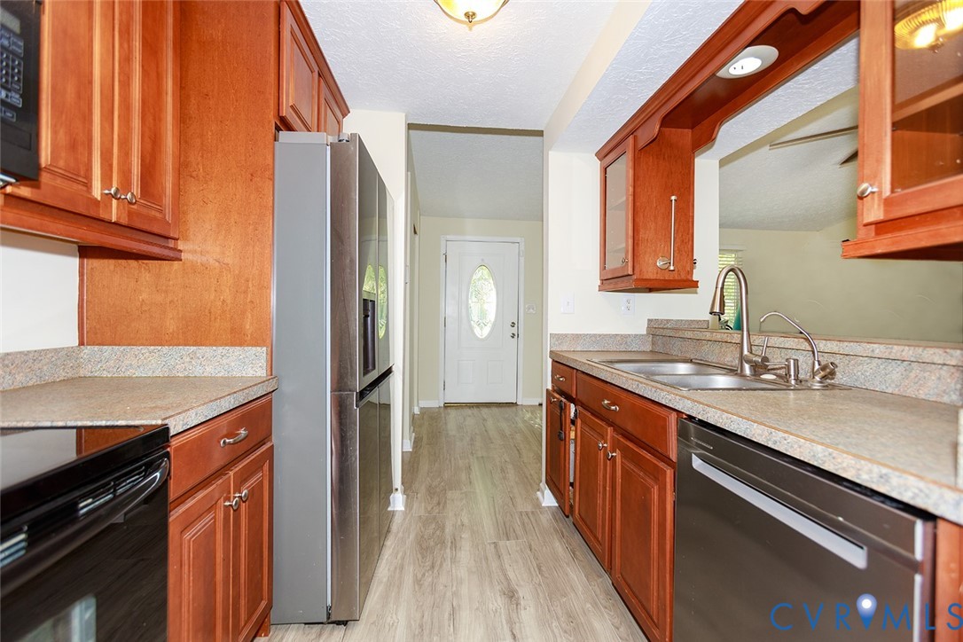 925 Fluvanna Road Newport News, VA 23601 - Photo 9 of 25 a kitchen with stainless steel appliances granite countertop a sink stove and refrigerator
