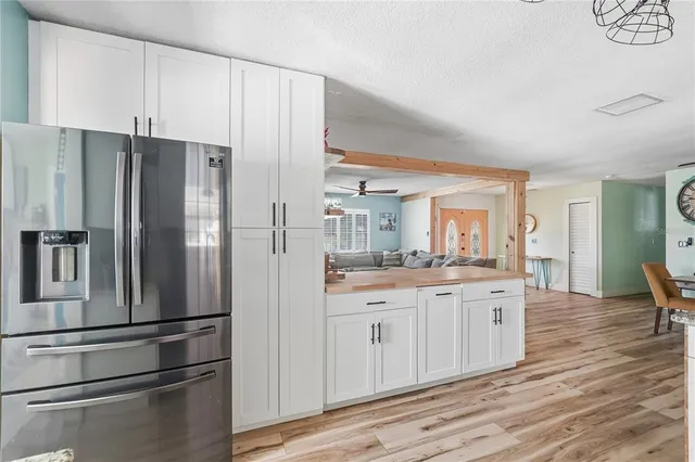 a kitchen with stainless steel appliances a refrigerator sink and cabinets