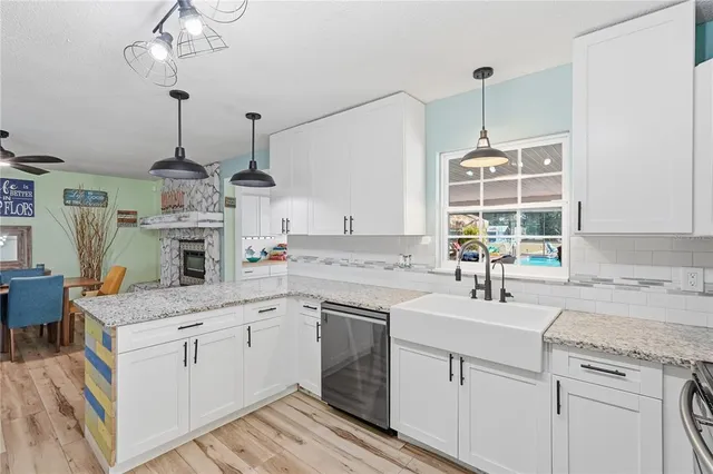 a kitchen with a sink stove and cabinets