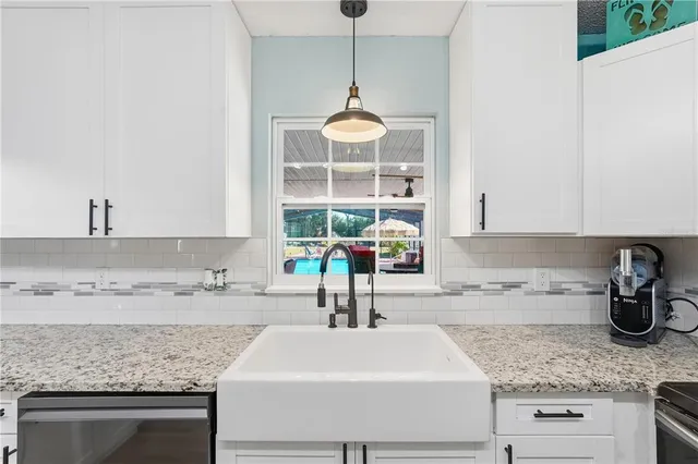 a kitchen with a sink and a stove top oven