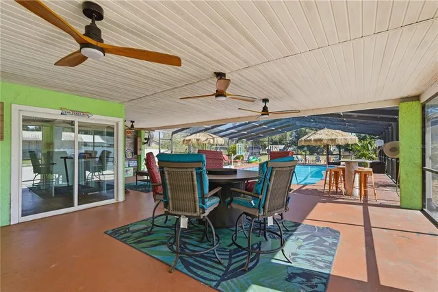 a view of a patio with table and chairs potted plants with wooden floor