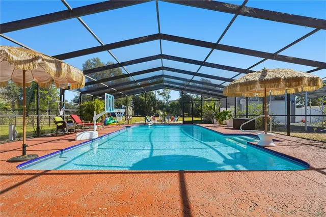 a view of a backyard with table and chairs under an umbrella
